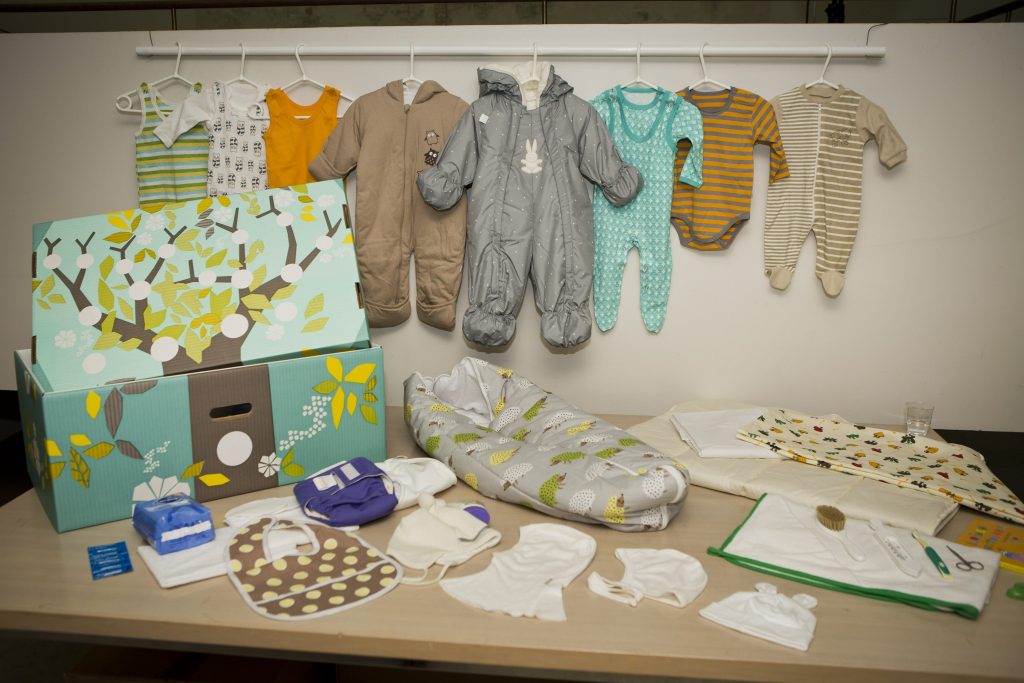 This photo taken on Aug. 15, 2012 shows the contents of the Finnish baby box, in Helsinki, Finland. Finland's social security service has given a baby box to Prince William and former Catherine Middleton, who are expecting their first baby in mid-July. The brightly colored cardboard box doubles as a cot, complete with mattress and sheets, and contains numerous baby items including a sleeping bag, jump suits, socks, pants, hats, bonnets and diapers. Maternity packages have been given to expectant mothers in Finland since 1938. (AP Photo/Lehtikuva, Roni Rekomaa) FINLAND OUT